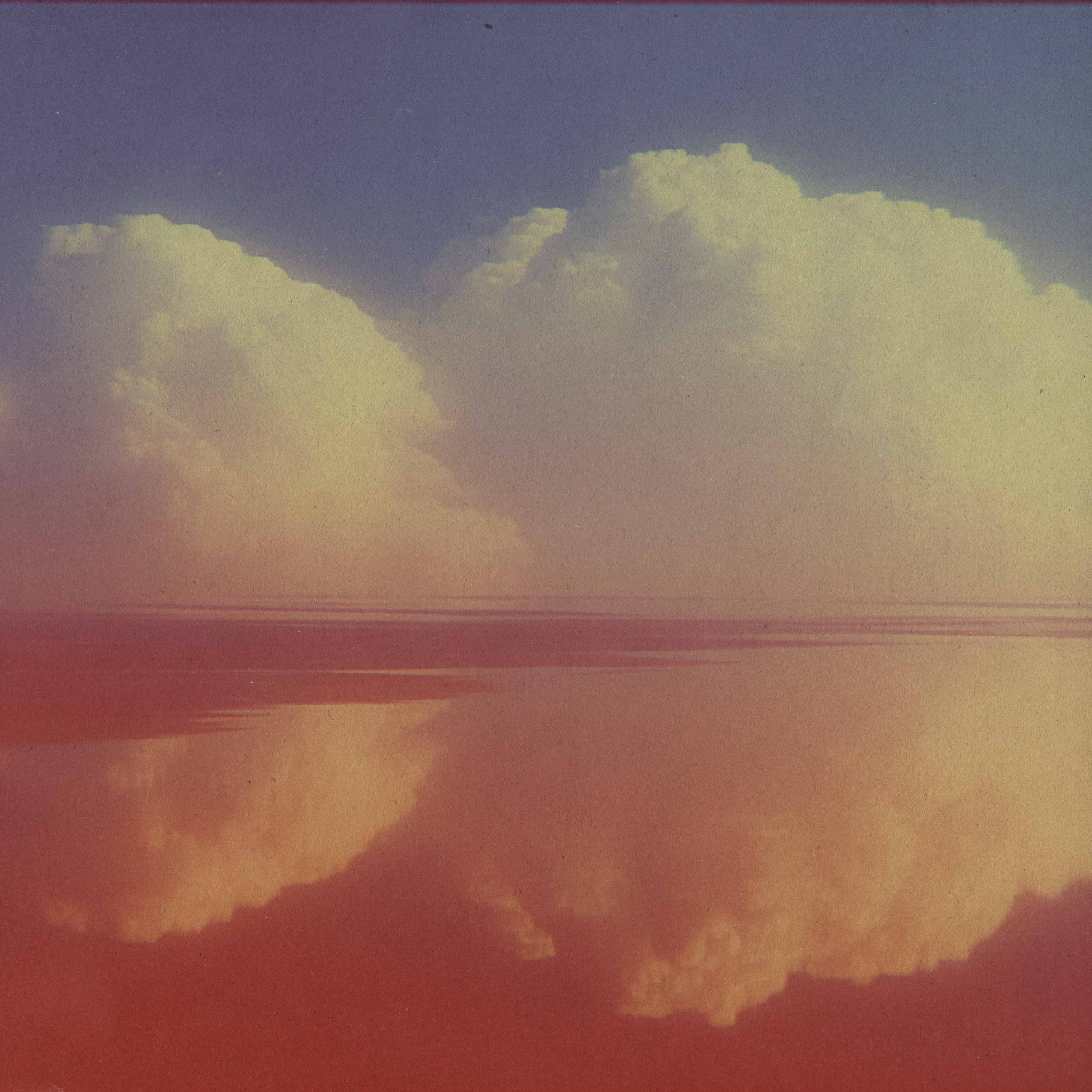 clouds reflected on water with sunset colors