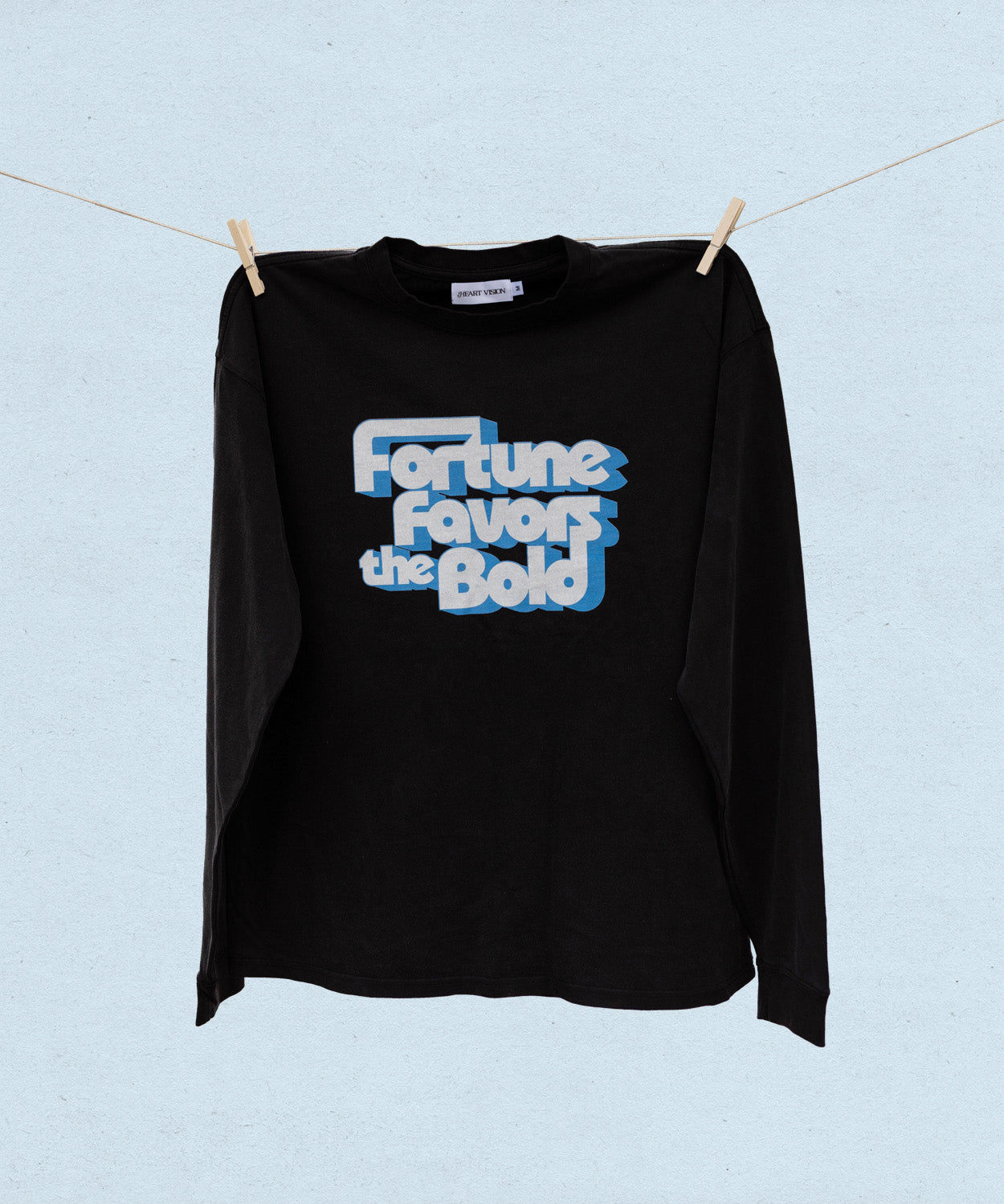 Black long sleeve t-shirt with 'Fortune Favors the Bold' text on a light blue background