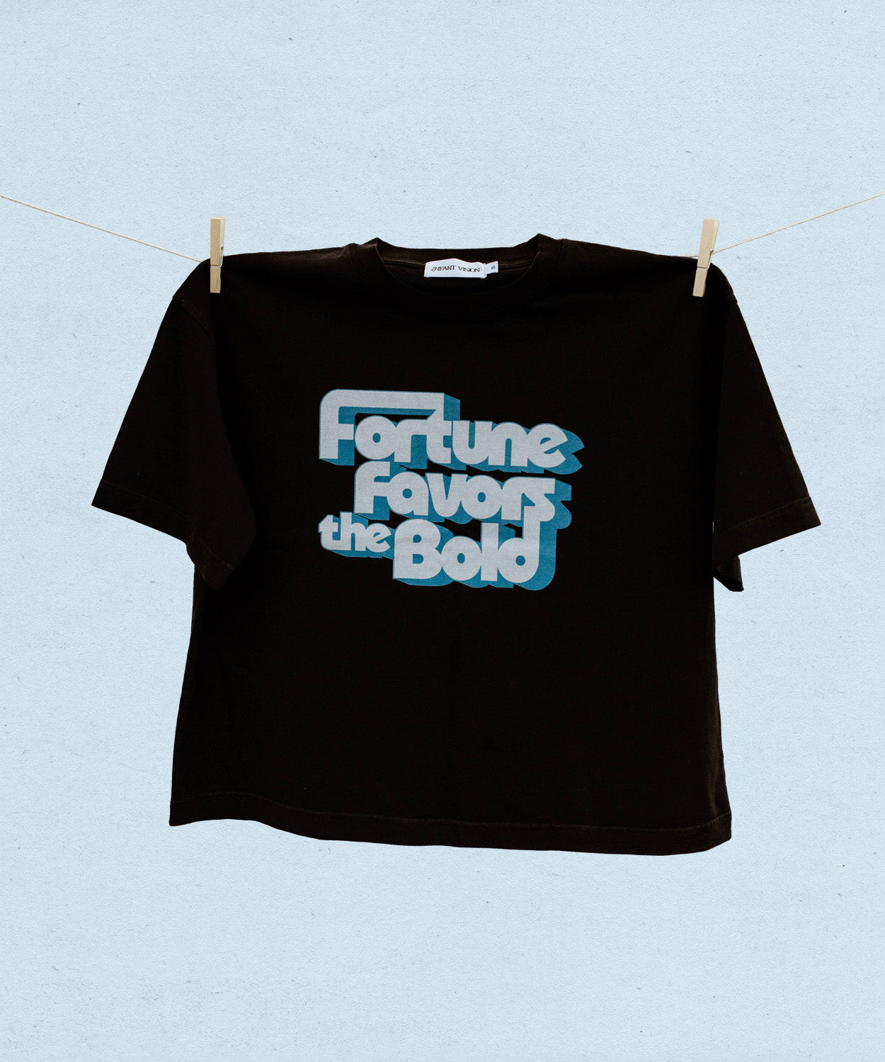 Black t-shirt with 'Fortune Favors the Bold' text on a light blue background