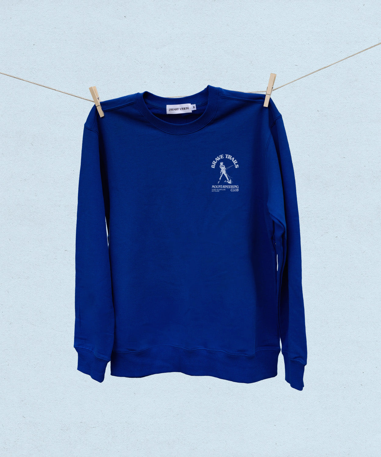 Blue sweatshirt with a logo on a clothesline against a light blue background