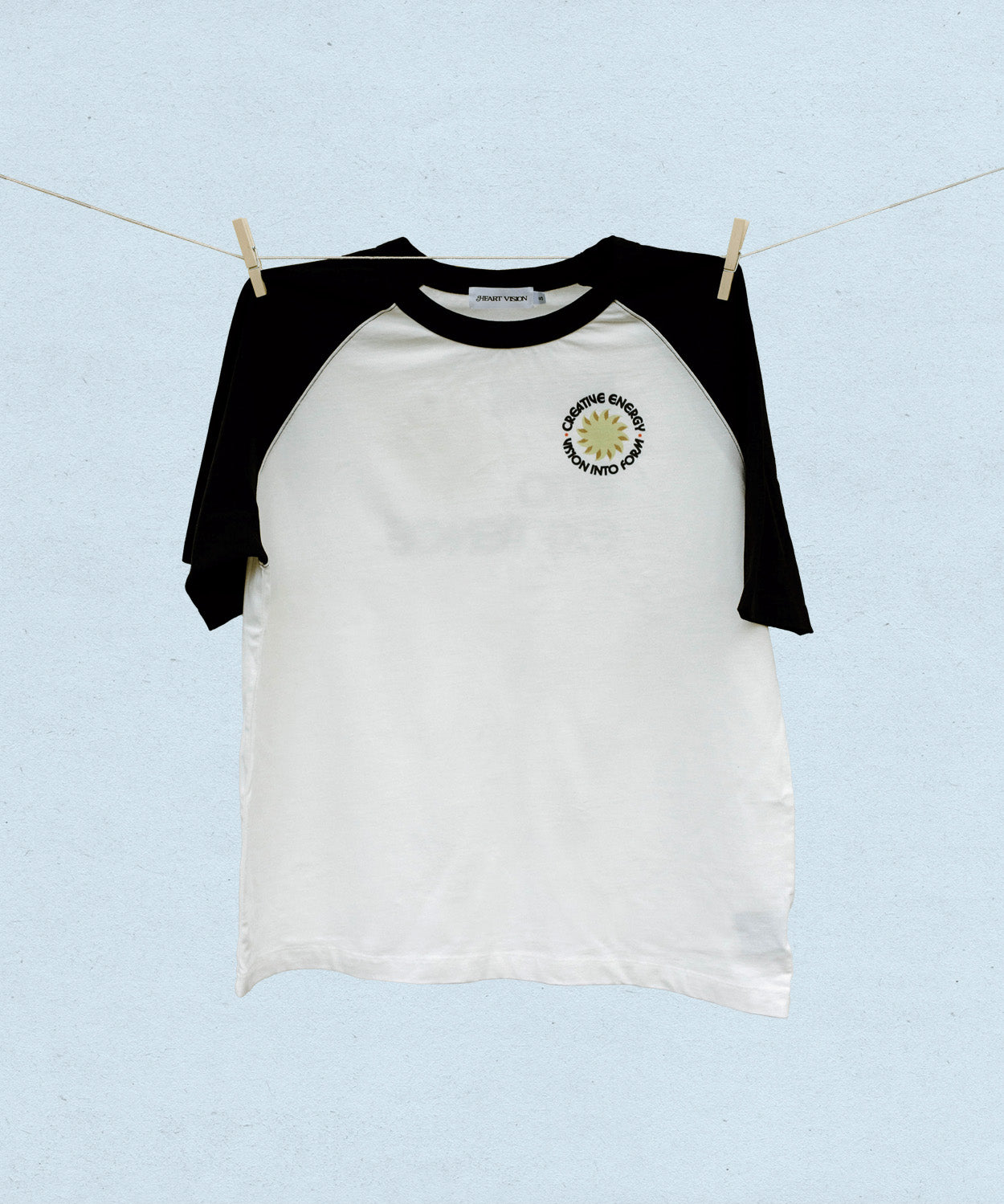 Black and white baseball t-shirt with a logo on a light blue background