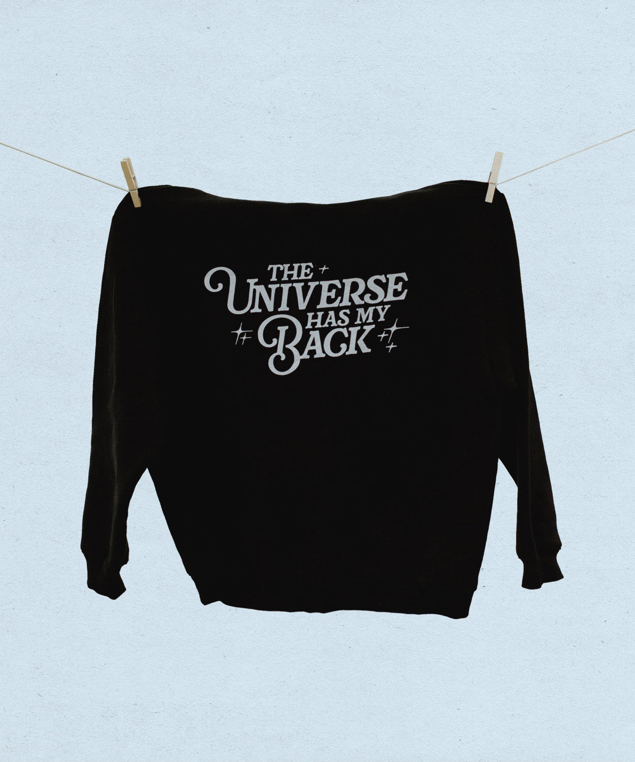 Black sweatshirt with 'The Universe Has My Back' text on a light blue background